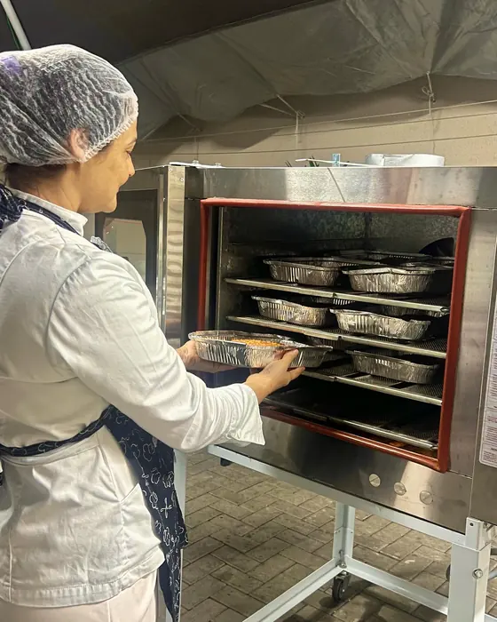 Elisabete conferindo os fornos industriais durante o evento